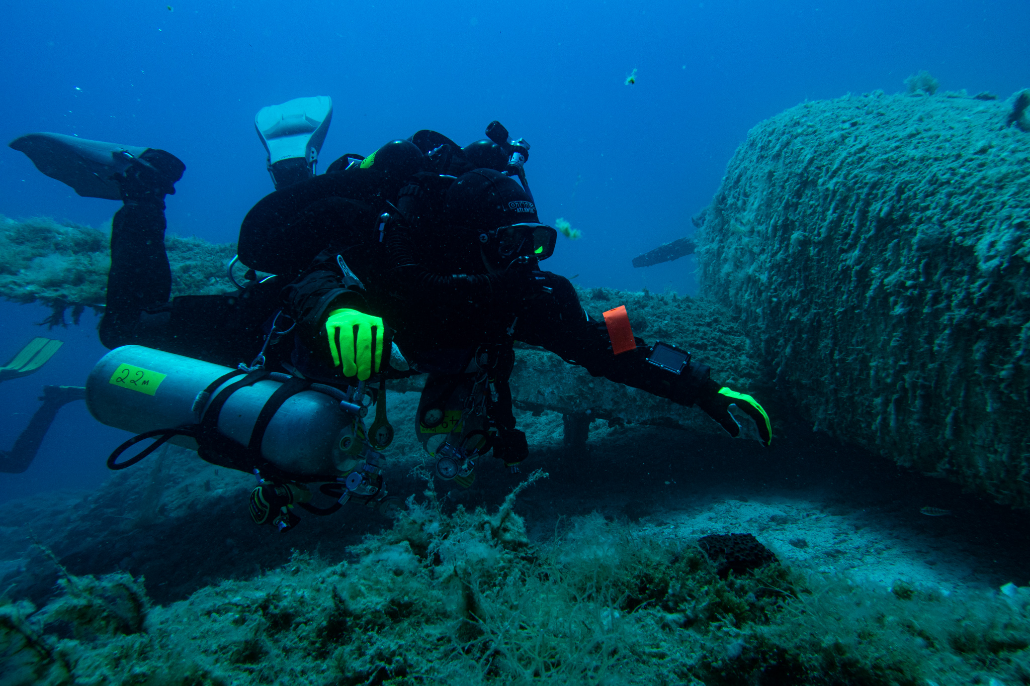 hovering rebreather diver next to a piper airplane wreck