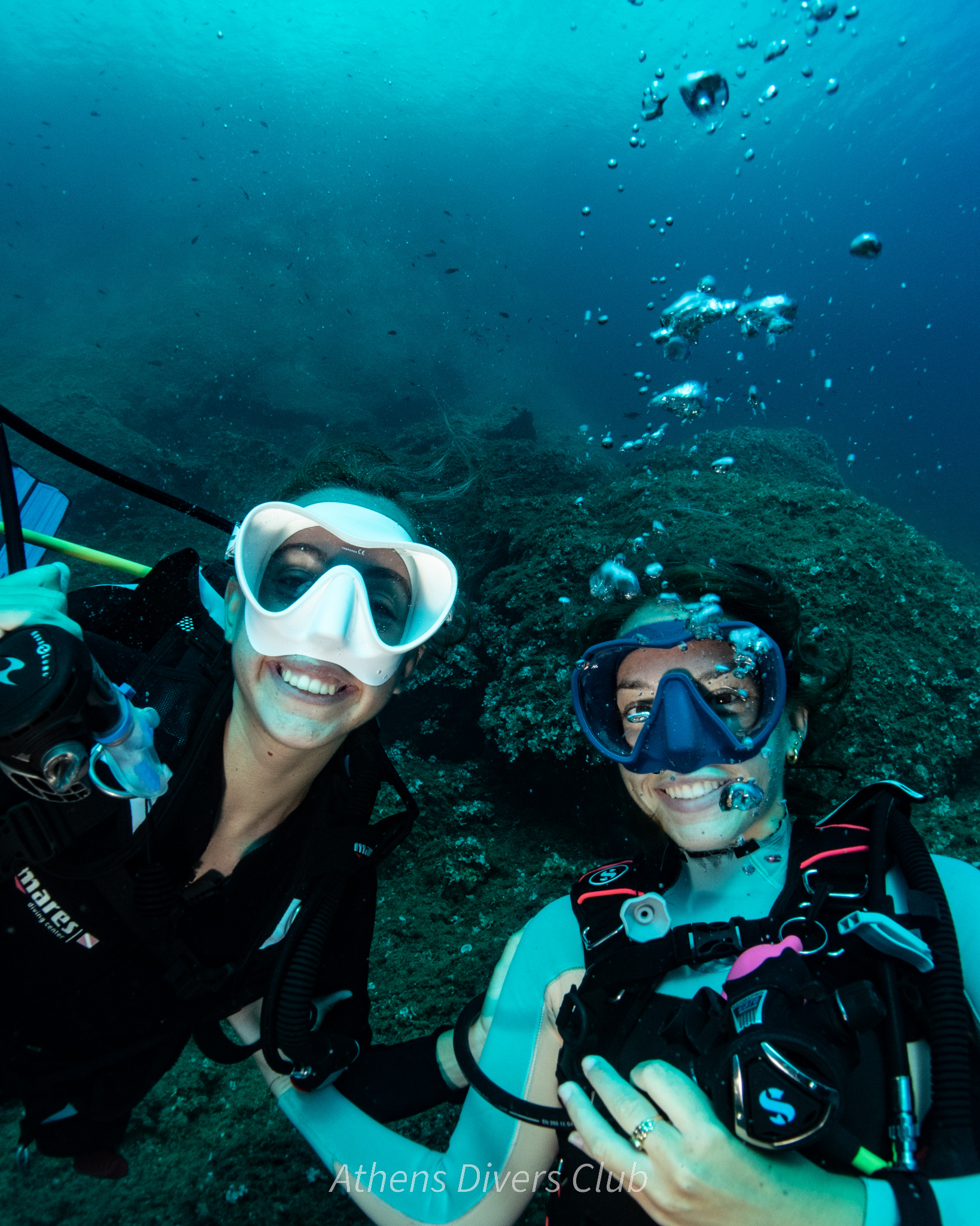 ladies divers smiling underwater withour regulators