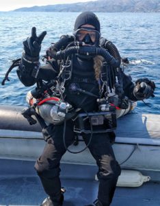 female rebreather diver on rib ready to dive